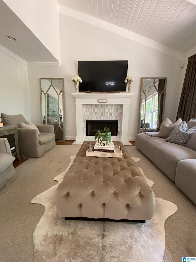 living room featuring carpet floors, a tiled fireplace, and vaulted ceiling