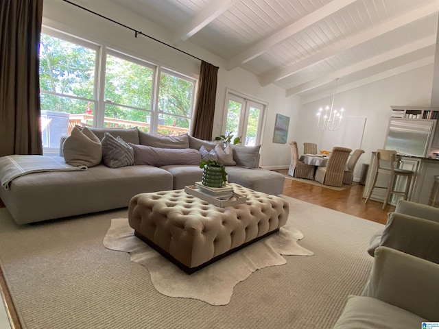 living room with vaulted ceiling with beams, a notable chandelier, and light hardwood / wood-style flooring