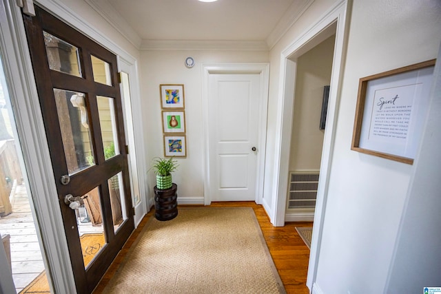 entrance foyer featuring crown molding and dark wood-type flooring