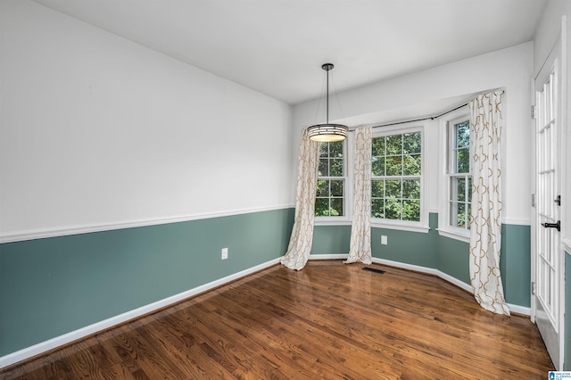 unfurnished room featuring hardwood / wood-style flooring