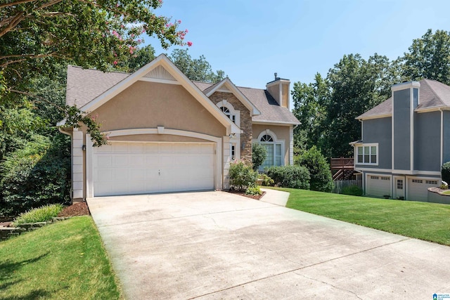 view of front of house featuring a garage and a front lawn