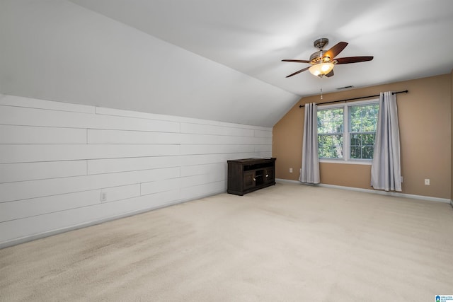 bonus room featuring ceiling fan, vaulted ceiling, and light carpet