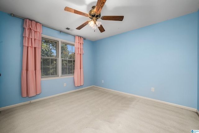 carpeted spare room with ceiling fan