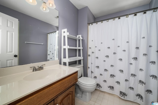 bathroom with tile patterned floors, vanity, and toilet