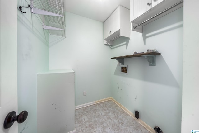 laundry room featuring washer hookup, cabinets, and light tile patterned floors