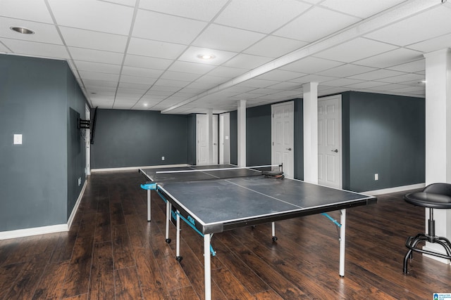 recreation room featuring a paneled ceiling and hardwood / wood-style floors