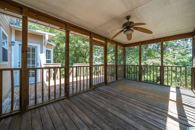 unfurnished sunroom with ceiling fan