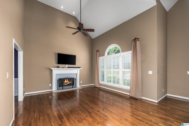 unfurnished living room with ceiling fan, high vaulted ceiling, and hardwood / wood-style flooring