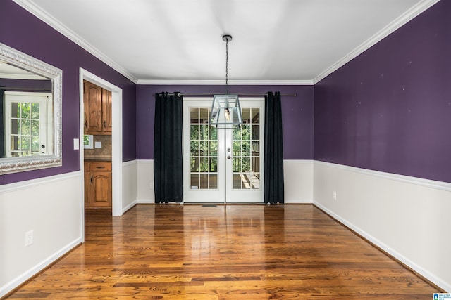 unfurnished dining area featuring ornamental molding, hardwood / wood-style flooring, and french doors