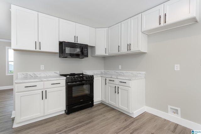 kitchen featuring light wood-type flooring, white cabinetry, and black appliances