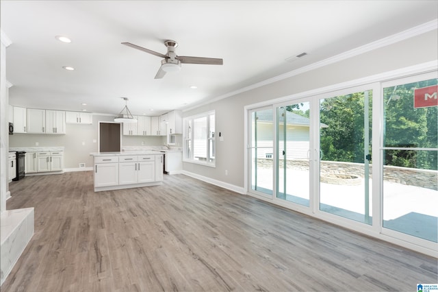 unfurnished living room with light hardwood / wood-style floors, ornamental molding, and ceiling fan