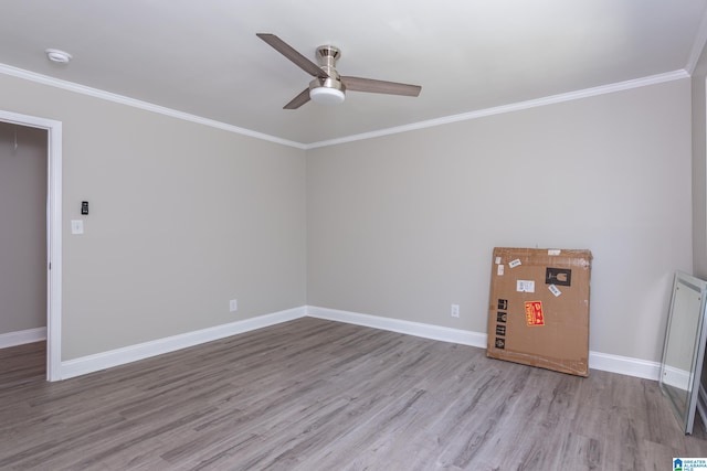 empty room featuring ceiling fan, ornamental molding, and hardwood / wood-style flooring