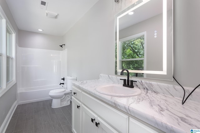 full bathroom with toilet, shower / bathing tub combination, and vanity