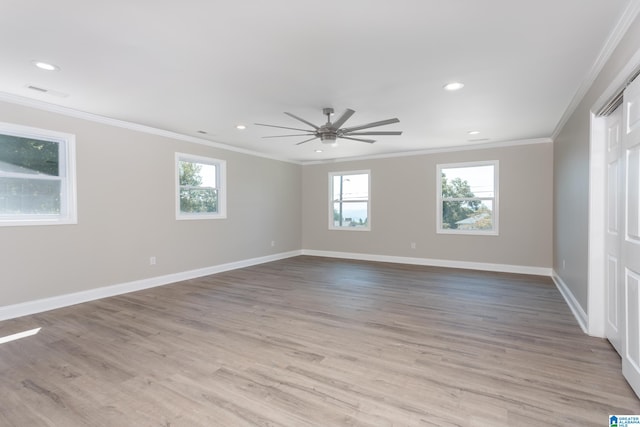 spare room featuring ceiling fan, crown molding, and light hardwood / wood-style flooring