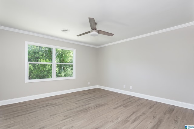 empty room with ceiling fan, hardwood / wood-style flooring, and crown molding