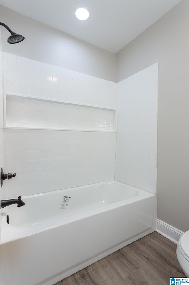 bathroom featuring toilet, hardwood / wood-style floors, and shower / tub combination