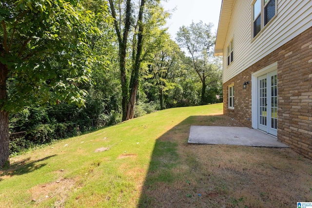 view of yard with a patio and french doors