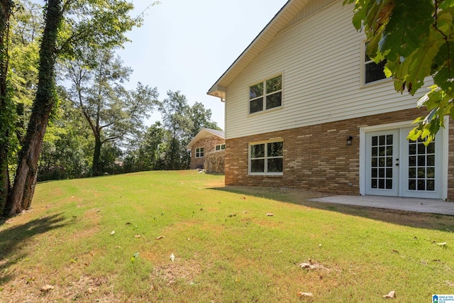 view of yard featuring a patio and french doors