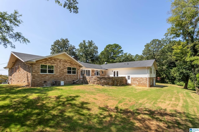 rear view of property with a lawn