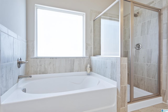 bathroom featuring tile patterned floors and shower with separate bathtub