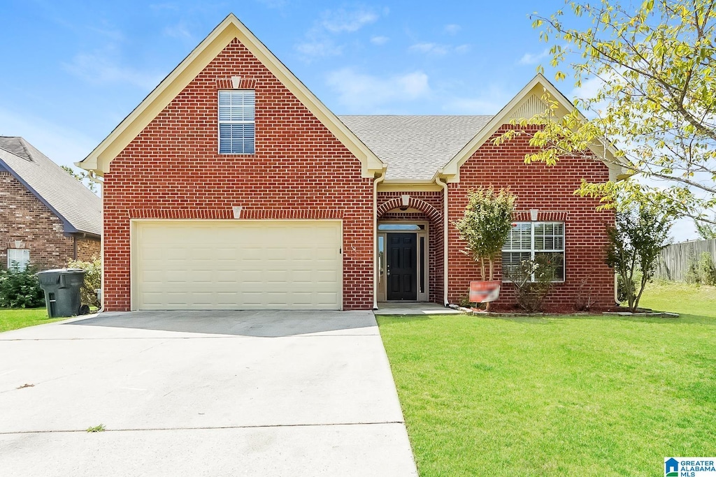 front facade featuring a garage and a front yard