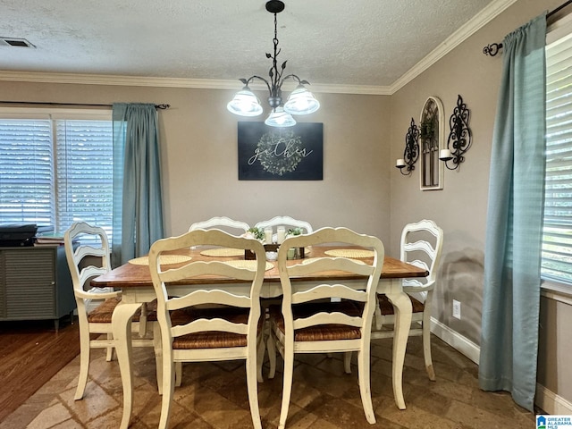 dining area featuring ornamental molding, a healthy amount of sunlight, an inviting chandelier, and wood-type flooring