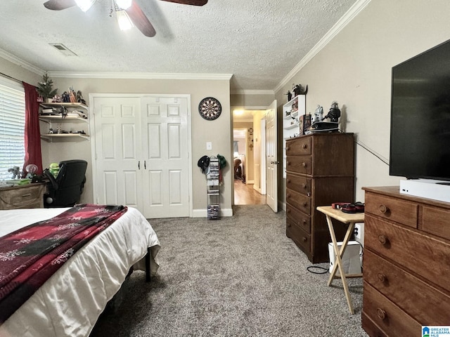 bedroom with a closet, a textured ceiling, light carpet, ceiling fan, and crown molding