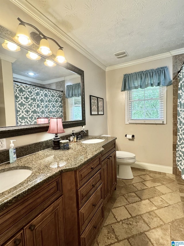 bathroom with toilet, vanity, tile patterned floors, a textured ceiling, and crown molding