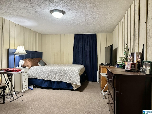 carpeted bedroom featuring a textured ceiling