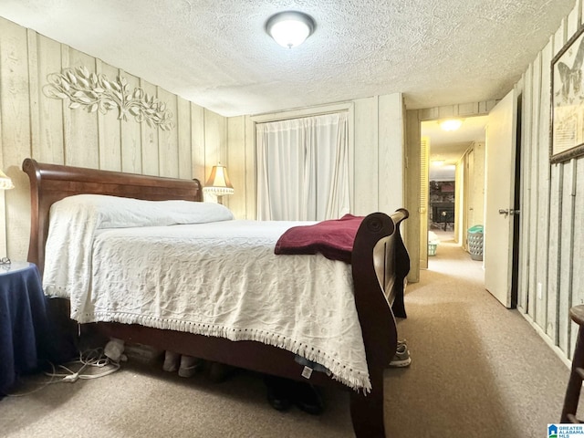 bedroom featuring a textured ceiling and light carpet