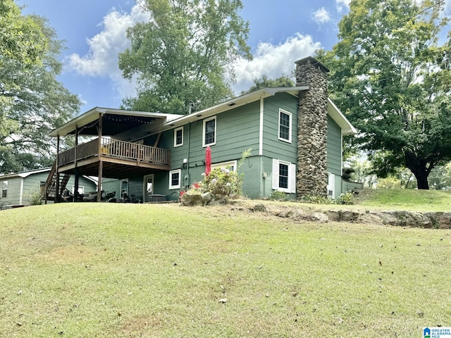 back of property with a wooden deck and a lawn