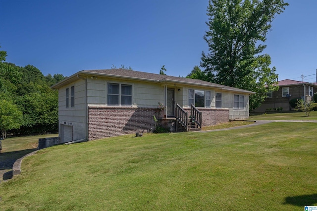 view of front of house with brick siding and a front lawn