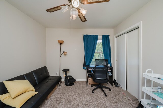 carpeted office space featuring ceiling fan