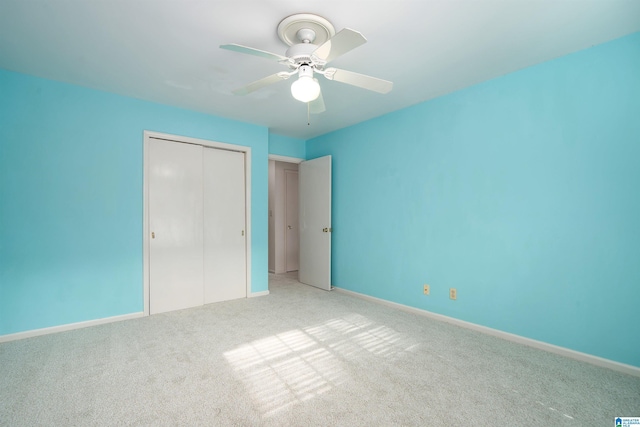 unfurnished bedroom with ceiling fan, a closet, and carpet