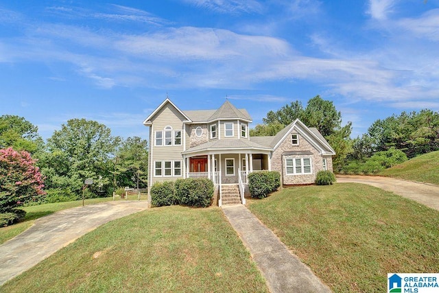 view of front of house featuring covered porch and a front lawn