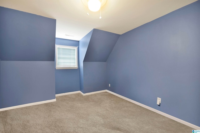 bonus room featuring vaulted ceiling, carpet, and baseboards