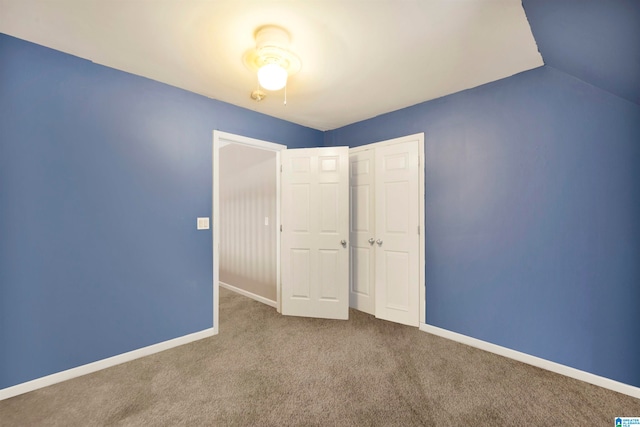 unfurnished bedroom with baseboards, a closet, and carpet flooring