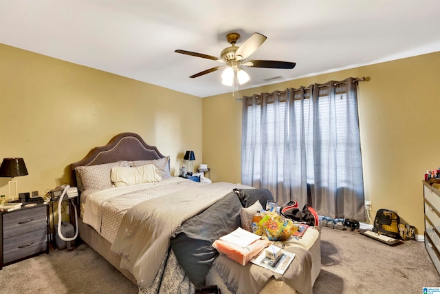 bedroom featuring light carpet, visible vents, and a ceiling fan