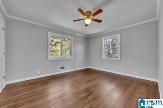 unfurnished bedroom with crown molding, dark wood finished floors, and baseboards