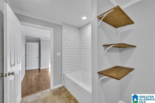 bathroom with tub / shower combination and baseboards