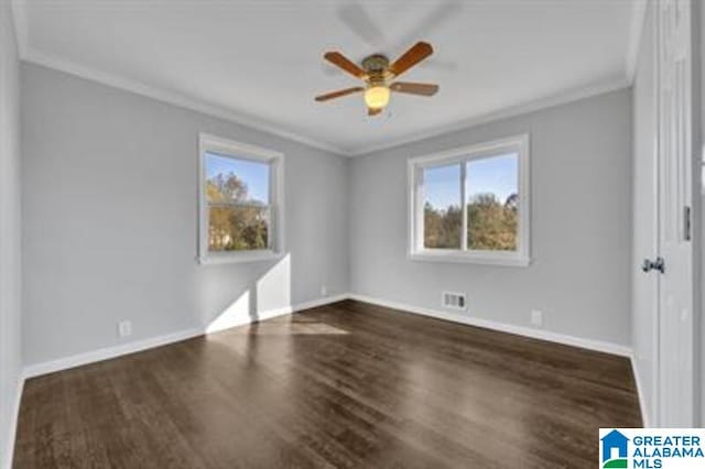 unfurnished bedroom with ceiling fan, visible vents, baseboards, dark wood-style floors, and crown molding