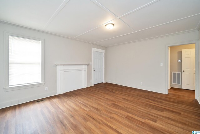 empty room with hardwood / wood-style floors and a healthy amount of sunlight