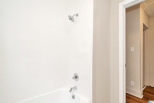 bathroom with shower / bathing tub combination and wood-type flooring