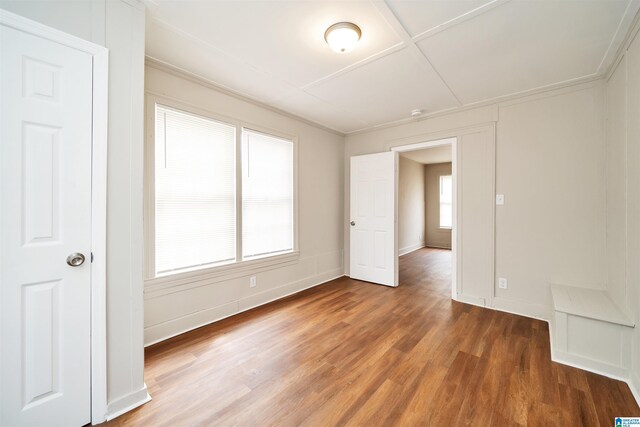 unfurnished room with hardwood / wood-style floors and a healthy amount of sunlight