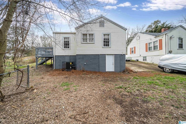 back of house with a wooden deck and central AC unit