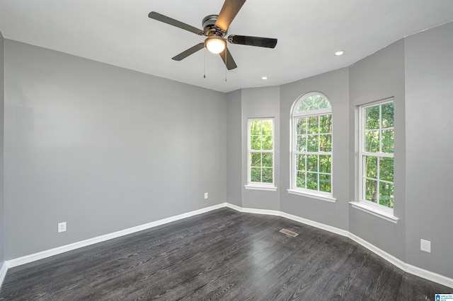 spare room with visible vents, baseboards, a ceiling fan, dark wood-type flooring, and recessed lighting