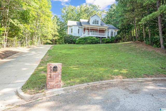 cape cod-style house with a porch and a front yard