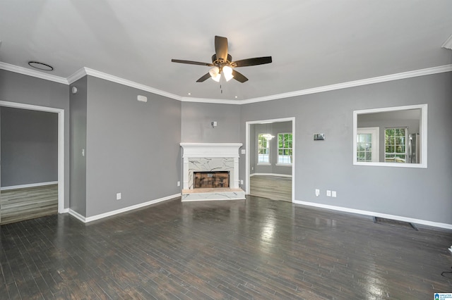 unfurnished living room with ceiling fan, a high end fireplace, hardwood / wood-style floors, and crown molding