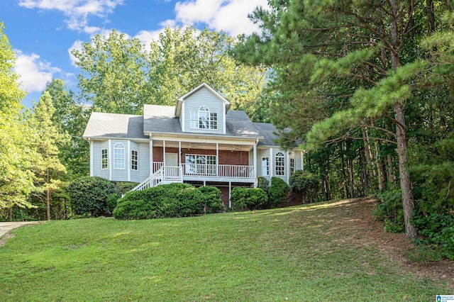 view of front of house featuring a porch, a front yard, and brick siding