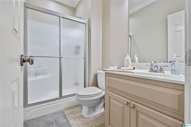 bathroom featuring vanity, a shower stall, and toilet